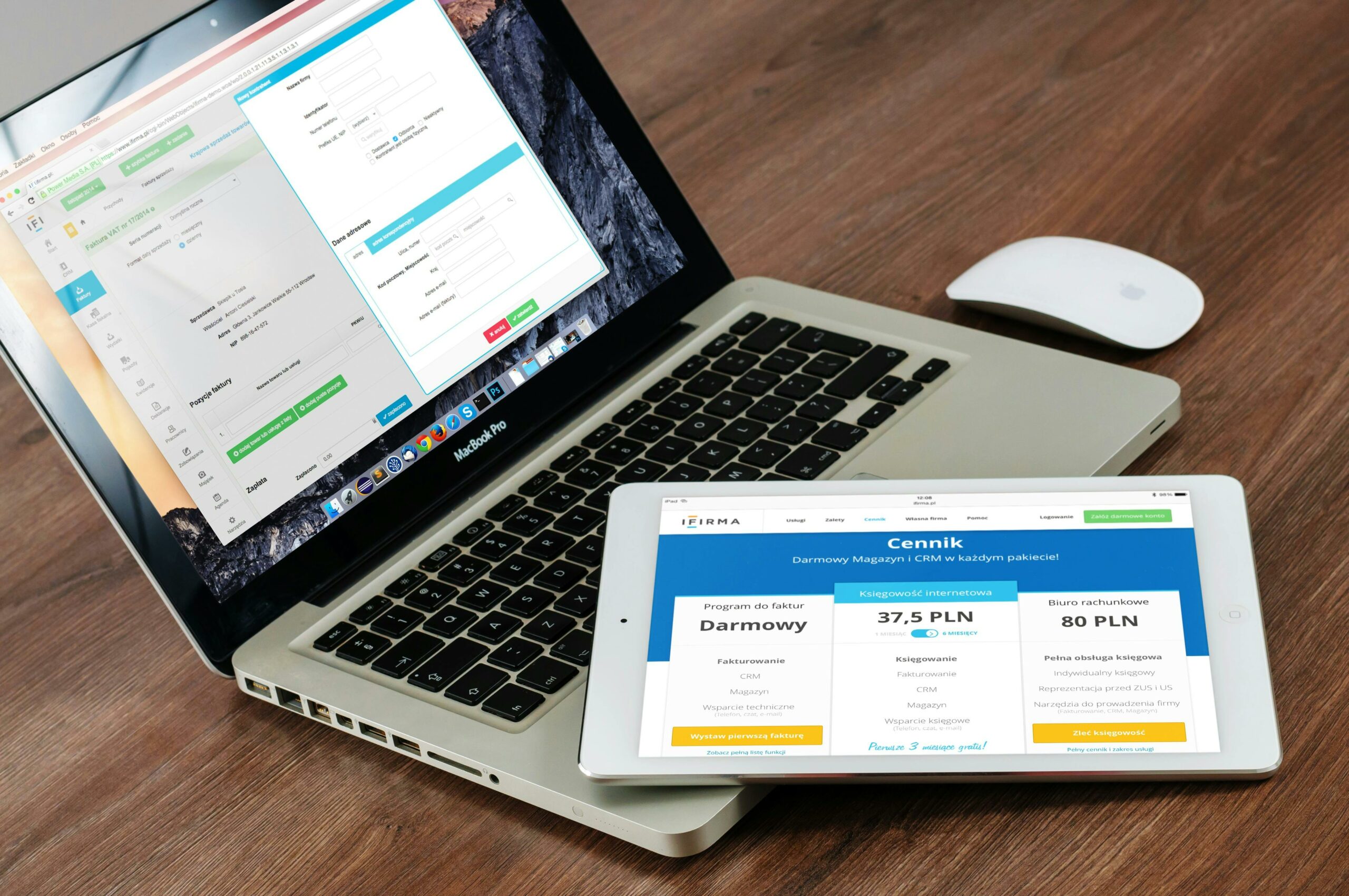 Traveler managing an online business with a laptop and tablet, using a CRM and billing software to run side hustles while traveling.